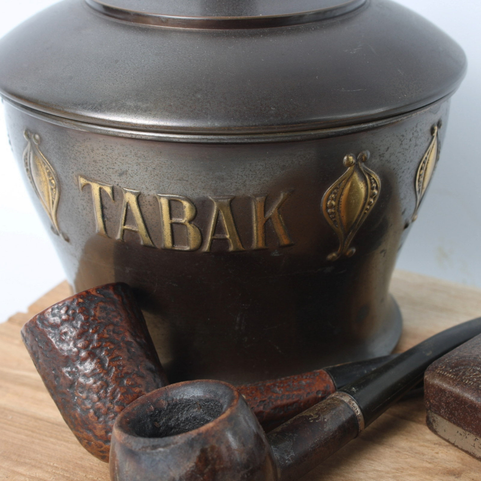Vintage metal tobacco jar with wooden pipes, tin box and rustic wooden tray