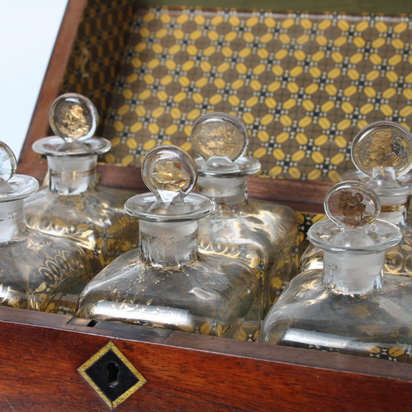 Antique mahogany liquor chest with six hand-blown gilded glass decanters