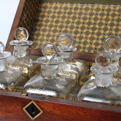 Antique mahogany liquor chest with six hand-blown gilded glass decanters