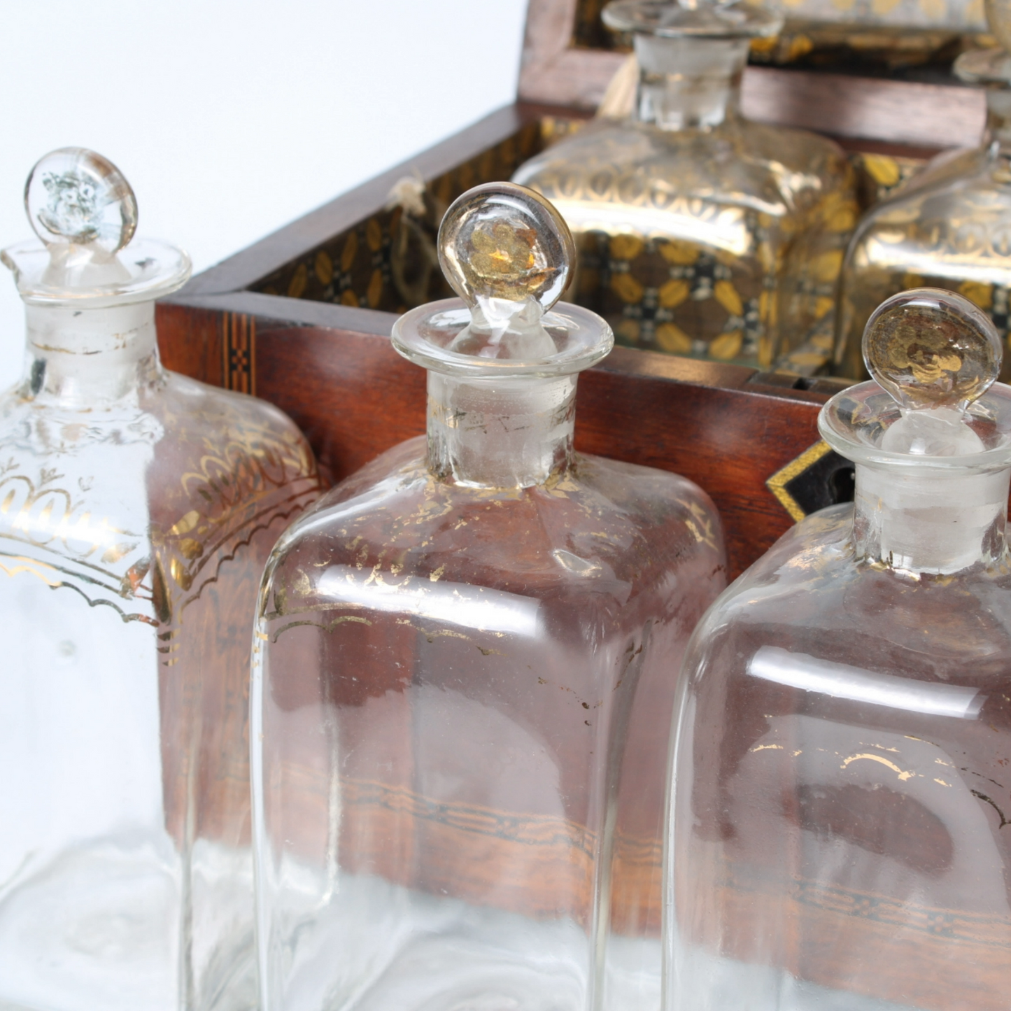 Antique mahogany liquor chest with six hand-blown gilded glass decanters