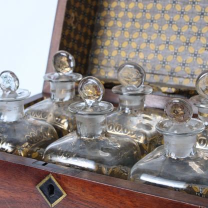 Antique mahogany liquor chest with six hand-blown gilded glass decanters